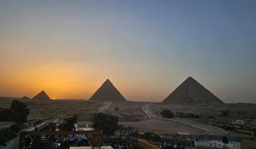 Sunset over the pyramids in Giza with a scenic view.