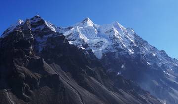 Snowy mountain peaks with clear blue sky.
