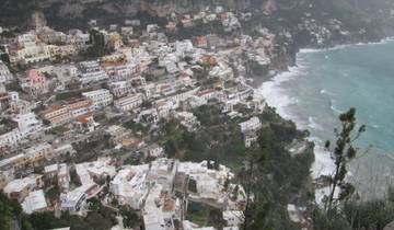 Aerial view of a coastal city with buildings along the shore.