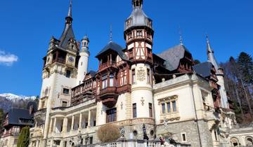 Ornate castle with multiple towers and decorative facades against a clear sky.
