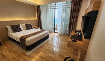 Hotel room with a view of the ocean.