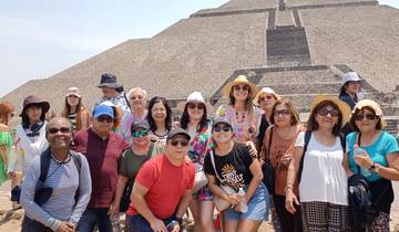Group posing in front of a pyramid.