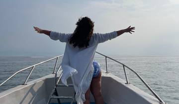 Person with arms outstretched on a boat.