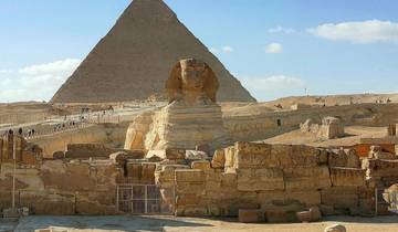 Famous ancient Sphinx statue before a large pyramid.