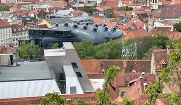 Cityscape with modern art museum, red rooftops.