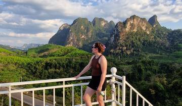 Woman enjoying mountain view from a terrace.