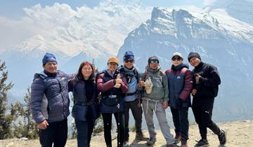 Group of hikers with snowy mountains in the background.