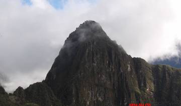 Mountain peak surrounded by mist and clouds.