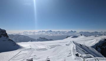 Snowy mountain landscape with clear blue sky.