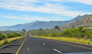 A long stretch of road with mountains in the distance.