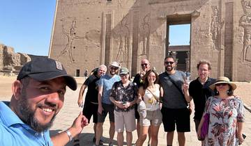 Tourists pose in front of the Edfu Temple.