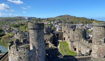 View over Conwy Castle with the town and hills in the background.