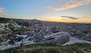 Panoramic view of Cappadocia with rock formations at sunset.