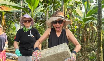 Person holding a brick, engaged in outdoor activity.