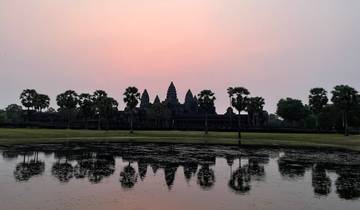 Sunset over Angkor Wat with reflection in the water.