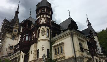 Ornate castle structure with dark roofs and overcast sky.