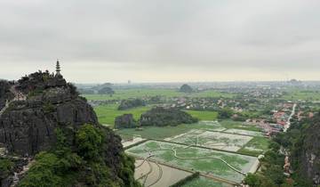 Panoramic landscape view with a pagoda on a mountain.