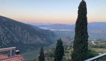 A serene valley view with mountains in the background during sunset.