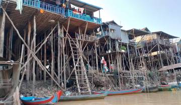 Stilt houses and boats along the water.