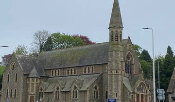 Historic stone church building with a pointed roof
