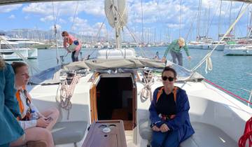 People on a yacht at a marina preparing to set sail.