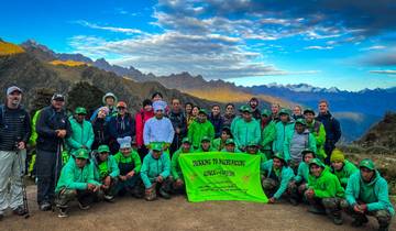 Group of people with a banner in the mountains.