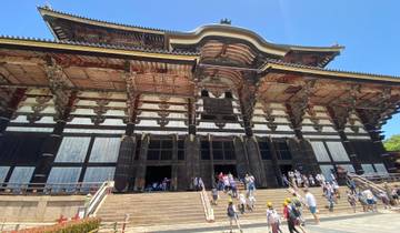 A large temple with visitors at the entrance.