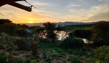 Scenic landscape with a sunset over a river.