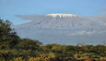 Mount Kilimanjaro peeking through clouds.