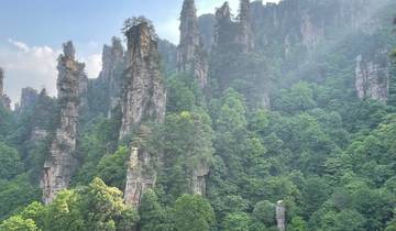 Tall, slender, rocky peaks covered with dense greenery.