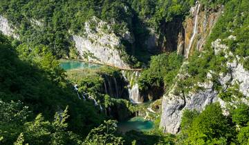 Scenic aerial view of cascading waterfalls and greenery.