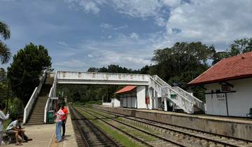Train station platform in Ella with people waiting.
