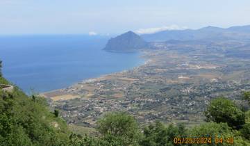 Panoramic view of a coastline with a mountain.
