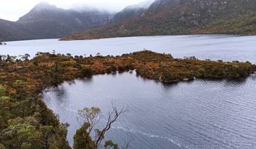 A scenic view of a lake surrounded by mountains.