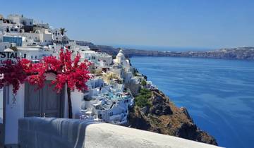 Picturesque seaside town with classic white and blue architecture.