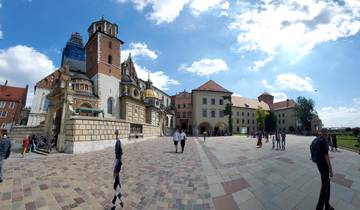 Wide view of a historical site with cathedral and tower.