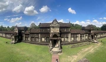 Panoramic view of an ancient structure surrounded by greenery.