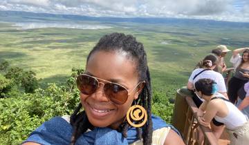 People overlooking a vast green landscape.
