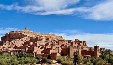 Historical fortified village with desert backdrop.