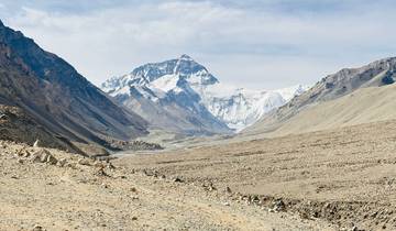 Vast mountainous landscape with snow-covered peaks.
