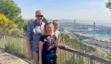 Couple posing with a panoramic view of a seaside city.