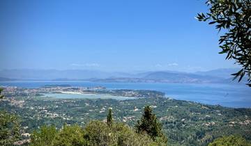 Scenic view of a coastline with hills and blue sea.