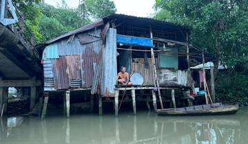 Old wooden house on stilts by the water.