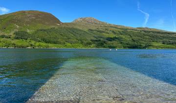 Beautiful lake with a mountainous background and clear water.