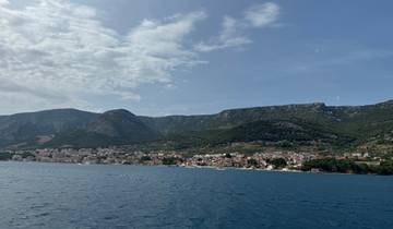 Coastal town with mountains in the background.