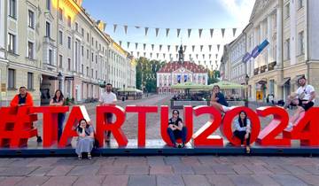Group posing with Tartu 2024 sign in the background.
