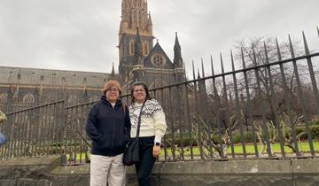 Two people posing in front of an iconic church.
