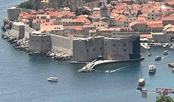 Close-up of Dubrovnik's city walls and a boat.