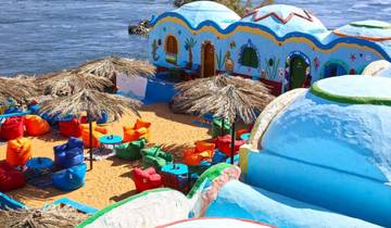 Colorful riverside café with vivid cushions and umbrellas.