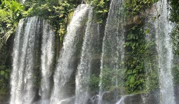 Waterfall cascading over rocks in a lush setting.